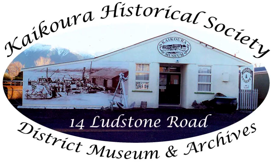 Kaikoura Historical Society District Museum and Archives building at 14 Ludstone Road, with white exterior, mountains in background, and historical photo mural on the side.